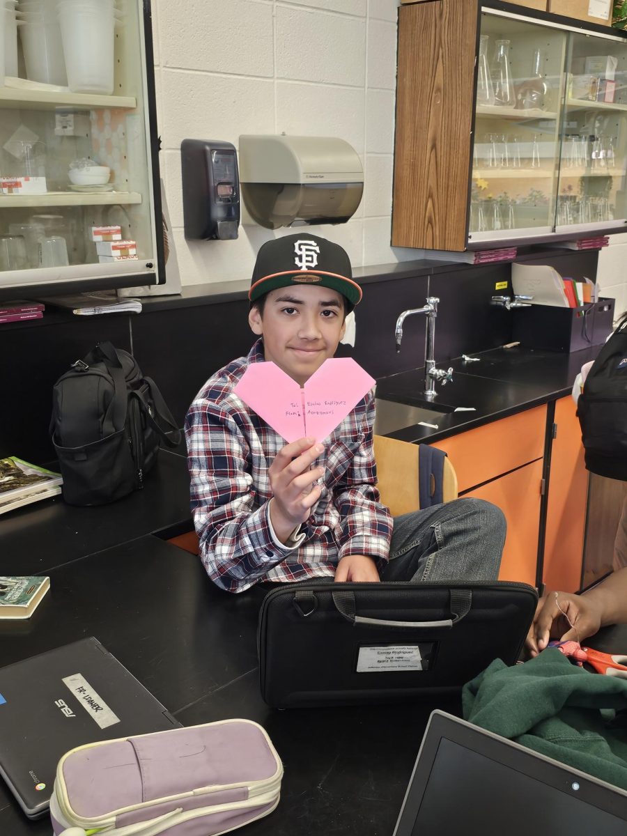 Esaias Rodriguez poses with his heart-shaped letter.